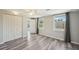 Bright bedroom featuring two windows, gray walls, ceiling fan, and wood-look flooring at 3207 Coldwell Dr, Holiday, FL 34691