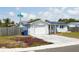 Charming single-story home featuring a brick and stucco facade, solar panels, and a well-manicured lawn at 3207 Coldwell Dr, Holiday, FL 34691