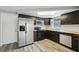Modern kitchen features stainless steel appliances, dark cabinets, and butcher block countertop at 3207 Coldwell Dr, Holiday, FL 34691