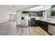 Modern kitchen features stainless steel appliances, dark cabinets, butcher block countertop, and tile backsplash at 3207 Coldwell Dr, Holiday, FL 34691