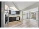Modern kitchen features stainless steel appliances, dark cabinets, and lots of natural light at 3207 Coldwell Dr, Holiday, FL 34691