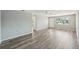 Bright living room features hardwood floors, lots of space, and a ceiling fan at 3207 Coldwell Dr, Holiday, FL 34691