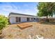 This home's backyard features mulch beds and a lush green tree at 3543 Rockaway Dr, Holiday, FL 34691