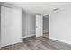 Neutral bedroom with hardwood style flooring, large closet, and white trim throughout at 3543 Rockaway Dr, Holiday, FL 34691