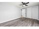 Bedroom featuring a ceiling fan, wood-look flooring, and a closet at 3543 Rockaway Dr, Holiday, FL 34691