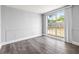 Bedroom featuring wainscoting, wood-look flooring, and lots of natural light at 3543 Rockaway Dr, Holiday, FL 34691