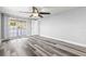 Light-filled bedroom featuring wood-look floors, neutral walls, and large window at 3543 Rockaway Dr, Holiday, FL 34691