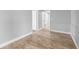Bedroom showcasing wood-look flooring, neutral walls, and access to hallway at 3543 Rockaway Dr, Holiday, FL 34691