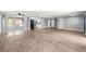 Spacious living room features wood-look tile flooring and sliding glass doors to the lanai at 3543 Rockaway Dr, Holiday, FL 34691