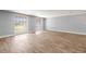 Sun-drenched living room with wood-look tile flooring and views of the backyard at 3543 Rockaway Dr, Holiday, FL 34691
