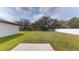 Expansive backyard featuring lush green grass, mature trees, and a privacy fence, perfect for outdoor enjoyment and entertaining at 35646 Eastbrook Ave, Zephyrhills, FL 33541