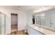 Bright bathroom boasts modern finishes, including a frameless glass shower and double sinks at 35646 Eastbrook Ave, Zephyrhills, FL 33541