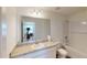 Bright bathroom with a large mirror, granite vanity and tile shower and tub combo at 35646 Eastbrook Ave, Zephyrhills, FL 33541