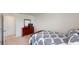 Bedroom with neutral carpet and a queen bed with blue and white patterned bedding at 35646 Eastbrook Ave, Zephyrhills, FL 33541