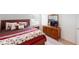 Comfortable bedroom features a wooden bed, matching dresser, and a bright window at 35646 Eastbrook Ave, Zephyrhills, FL 33541