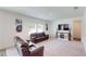 Comfortable living room features a large flat screen television and cozy seating at 35646 Eastbrook Ave, Zephyrhills, FL 33541