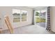 Neutral-toned bedroom with sliding glass doors to the backyard at 36727 Spanish Rose Dr, Dade City, FL 33525