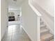 Hallway with gray-toned tile flooring and gray-toned stairs at 36727 Spanish Rose Dr, Dade City, FL 33525