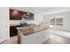 Kitchen with granite counters and an island that opens into a casual eating area at 36727 Spanish Rose Dr, Dade City, FL 33525