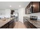 Kitchen with stainless steel appliances, granite counters, and tile flooring at 36727 Spanish Rose Dr, Dade City, FL 33525