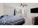 Bright main bedroom with a ceiling fan, ensuite bathroom access, and space for a crib at 36727 Spanish Rose Dr, Dade City, FL 33525