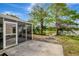 Backyard view with screened patio, large trees, and serene lake backdrop at 4111 Stratfield Dr, New Port Richey, FL 34652