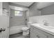 Updated bathroom with gray vanity, shower-tub combo, and grey plank flooring at 4111 Stratfield Dr, New Port Richey, FL 34652