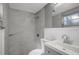 Modern bathroom with tiled shower, new vanity, and a bright window at 4111 Stratfield Dr, New Port Richey, FL 34652