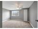 Bedroom features neutral carpet, ceiling fan, and closet at 4111 Stratfield Dr, New Port Richey, FL 34652