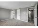 Bedroom with gray walls, carpet, and multiple doors leading to other areas at 4111 Stratfield Dr, New Port Richey, FL 34652