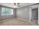 Bedroom features neutral carpet and paint, and a large window at 4111 Stratfield Dr, New Port Richey, FL 34652