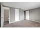 Bedroom with multiple doors, gray walls, and carpet leading to a bathroom at 4111 Stratfield Dr, New Port Richey, FL 34652