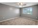 Bedroom with neutral carpet, ceiling fan and window at 4111 Stratfield Dr, New Port Richey, FL 34652