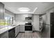 Modern kitchen with gray cabinets, stainless steel appliances, and a bright, open layout at 4111 Stratfield Dr, New Port Richey, FL 34652