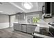 Well-lit kitchen featuring gray cabinets, stainless steel appliances, and white countertops overlooking the backyard at 4111 Stratfield Dr, New Port Richey, FL 34652