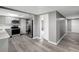 Modern kitchen featuring gray cabinets, stainless steel appliances, and sleek countertops, with a view into the hallway at 4111 Stratfield Dr, New Port Richey, FL 34652