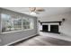Bright living room with a large window and brick fireplace offers a cozy space at 4111 Stratfield Dr, New Port Richey, FL 34652