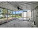 Screened patio area featuring a ceiling fan and beautiful lake views at 4111 Stratfield Dr, New Port Richey, FL 34652