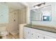Bright bathroom featuring a granite countertop, glass sink, and tiled shower at 4344 Outrigger Ln, Tampa, FL 33615