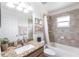 Bathroom with tiled shower and tub, toilet, and granite countertop vanity with mirror at 5253 1St N Ave, St Petersburg, FL 33710