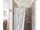 Bathroom shower featuring stylish tiled walls and shower with white and black patterned shower curtain at 5253 1St N Ave, St Petersburg, FL 33710