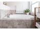 Bathroom featuring a large soaking tub with tile surround and a plant at 5253 1St N Ave, St Petersburg, FL 33710