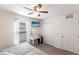 Bright bedroom featuring ceiling fan, television, vanity, and double closets at 5253 1St N Ave, St Petersburg, FL 33710