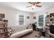 Bedroom with ceiling fan, futon, and desk area with bright light from the window at 5253 1St N Ave, St Petersburg, FL 33710