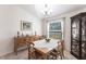 Cozy dining area with a wooden table set, elegant chandelier, and a large window at 5253 1St N Ave, St Petersburg, FL 33710