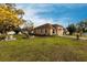 Well-maintained lawn and picturesque view of a single-story home with a striking yellow flowering tree at 5253 1St N Ave, St Petersburg, FL 33710