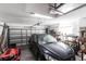 Garage featuring a car, lawn mower, shelves and garage door at 5253 1St N Ave, St Petersburg, FL 33710