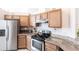 Well-lit kitchen featuring stainless steel appliances and light wood cabinetry at 5253 1St N Ave, St Petersburg, FL 33710
