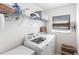 Laundry room featuring a washer, dryer, shelving and a window with bright light at 5253 1St N Ave, St Petersburg, FL 33710