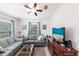 Comfortable living room featuring a ceiling fan, natural lighting, and stylish furnishings at 5253 1St N Ave, St Petersburg, FL 33710
